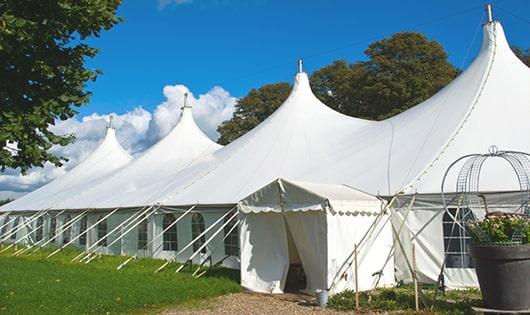 tall green portable restrooms assembled at a music festival, contributing to an organized and sanitary environment for guests in Mountainside